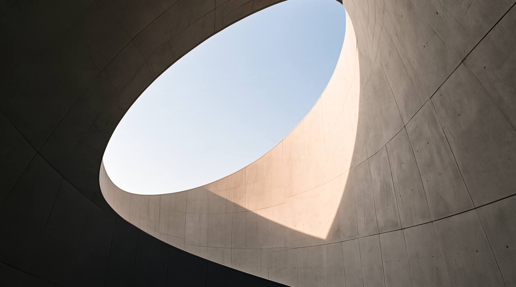 Oval opening in a concrete ceiling onto the sky