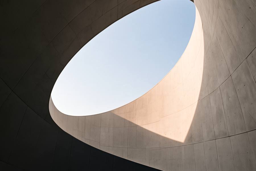 Oval opening in a concrete ceiling onto the sky