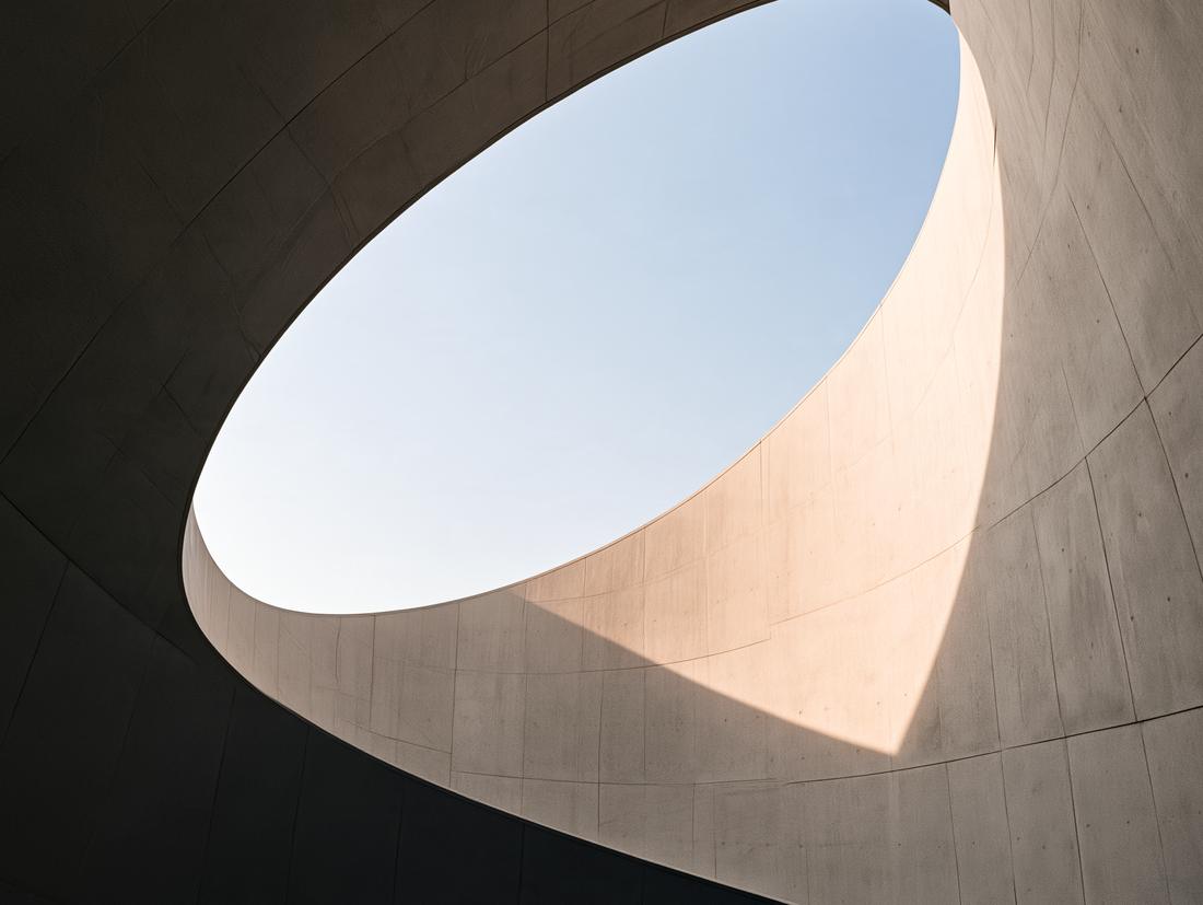 Oval opening in a concrete ceiling onto the sky